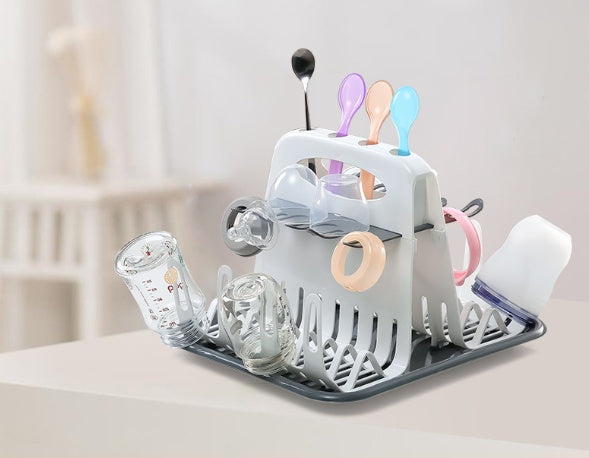White multi-tier dish rack with utensil cups and dark grey base