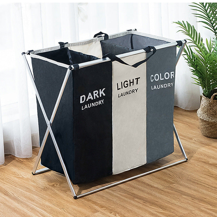Three-compartment collapsible laundry hamper with fabric dividers, dark and light panels, metal stand