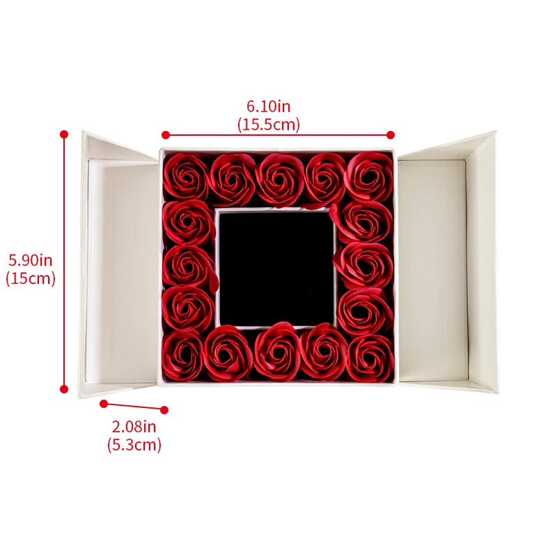Open jewelry box gift set showing red rose arrangement and black center tray
