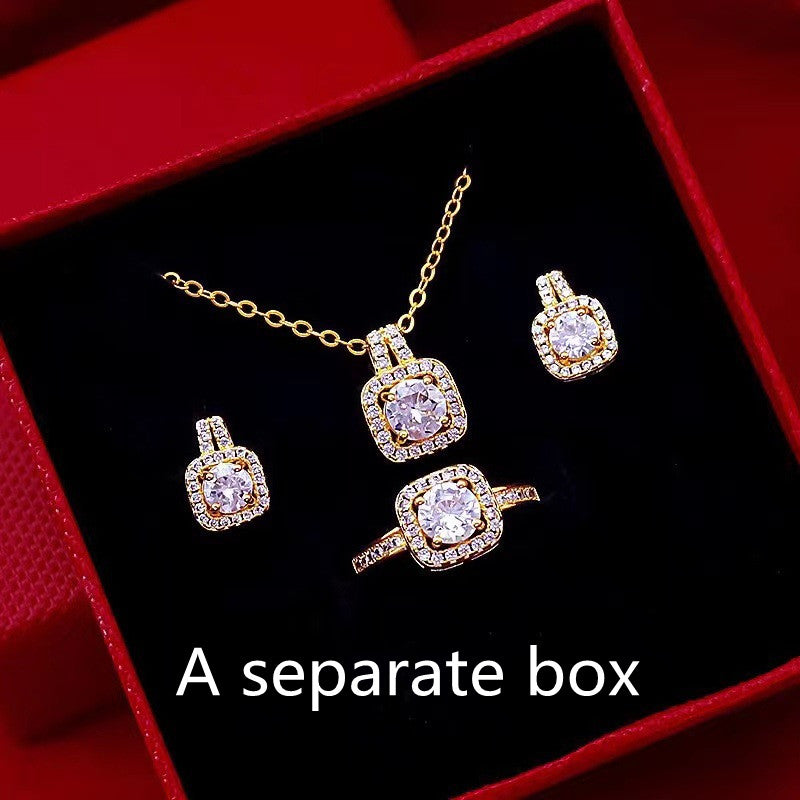 Gold zircon jewelry set with square pendant choker, stud earrings, and ring in box