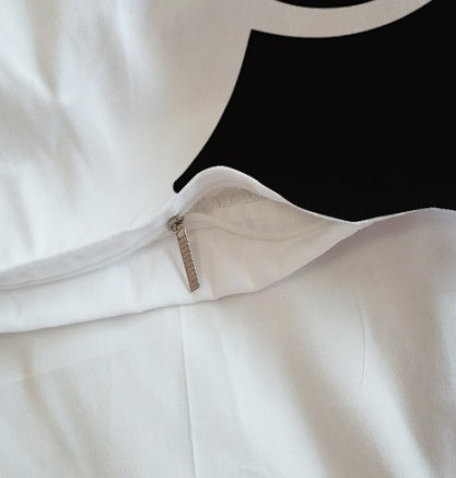 Duvet cover close-up in white with visible seam and beige zipper tab