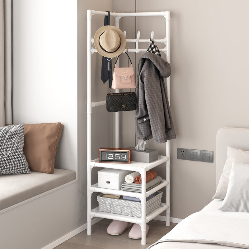 White corner coat rack with hanging hooks and stacked open shelves for folded items