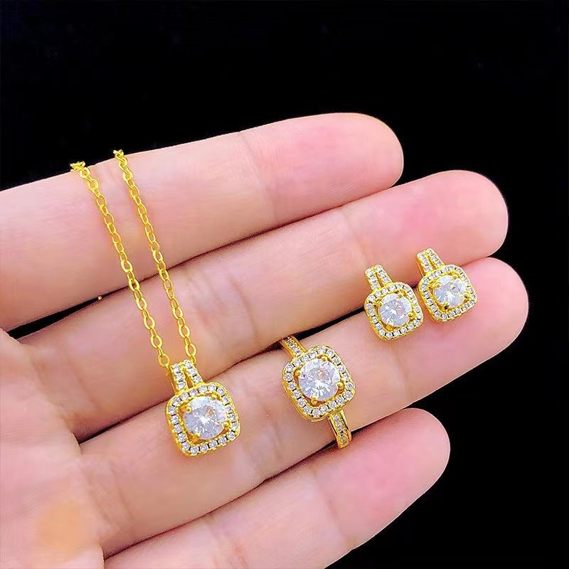 Gold zircon choker pendant necklace, square stud earrings, and ring shown on hand