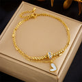 Gold double-layer heart anklet with linked chains, cylindrical center clasp, and heart charm