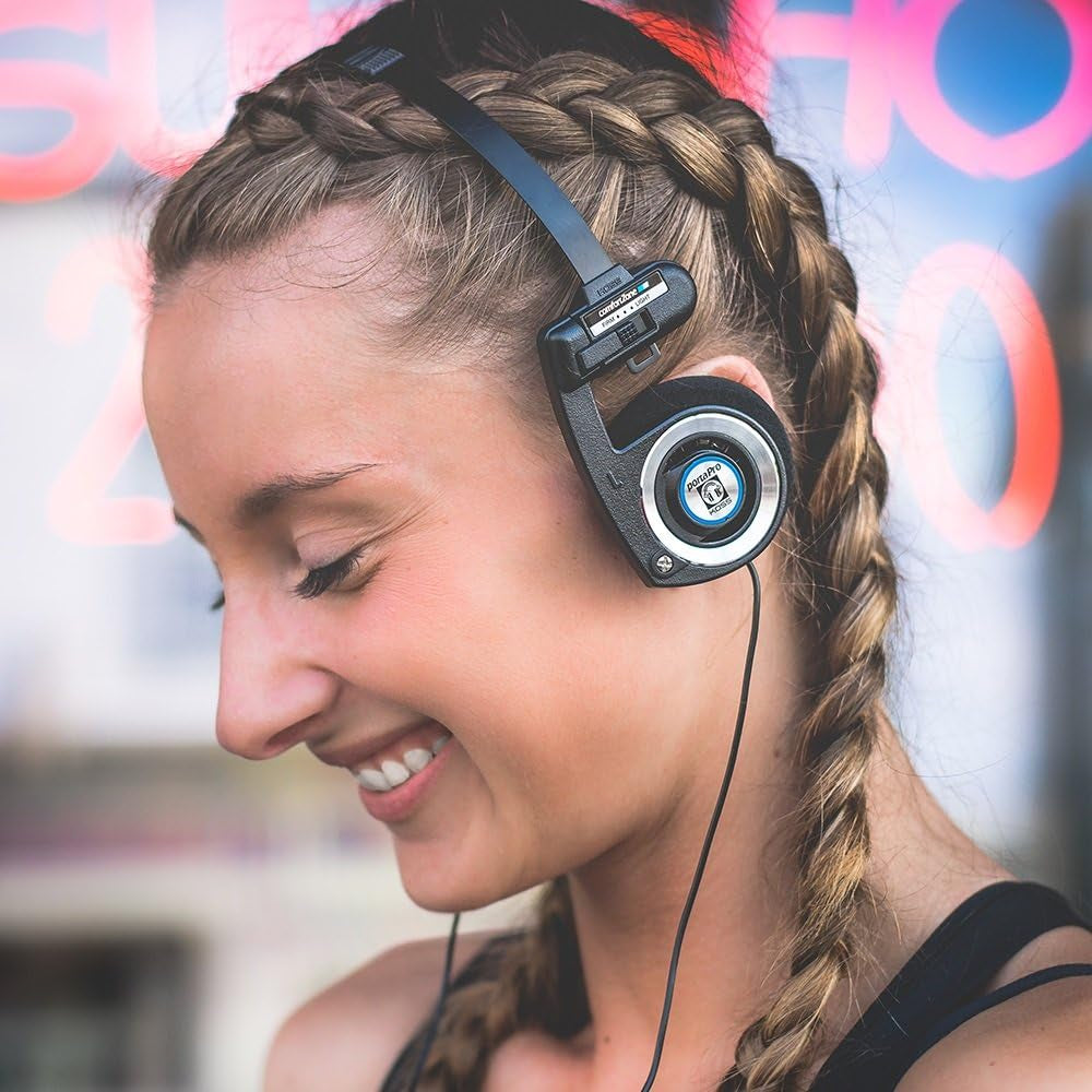 Black on-ear headphones on a woman’s head with padded earcups