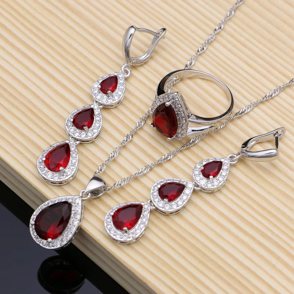 Sterling silver jewelry set with red teardrop gemstones, earrings and necklace