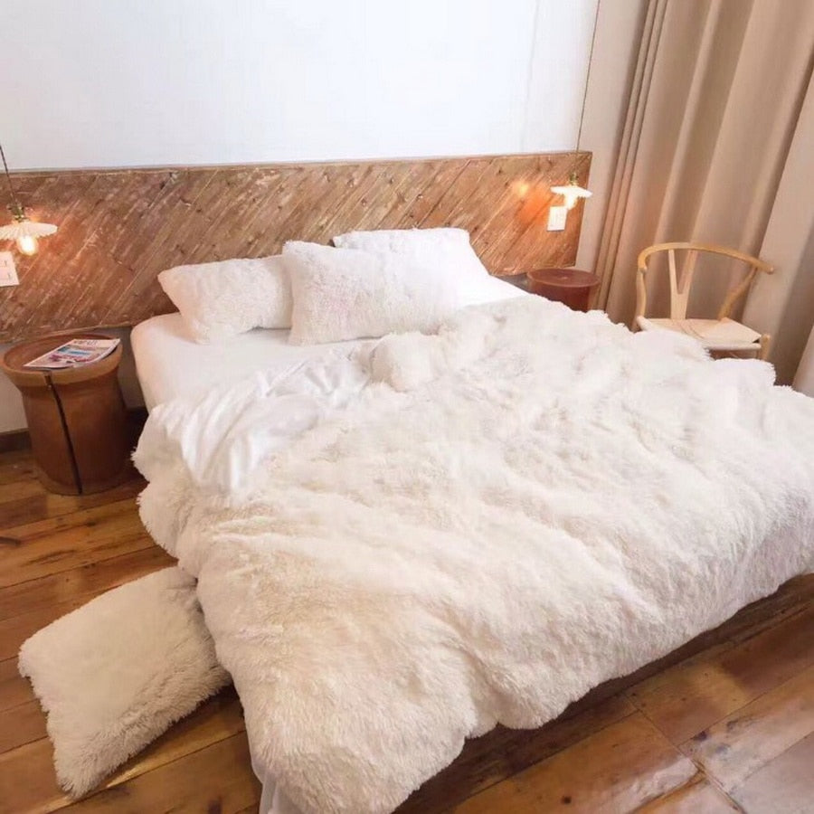 Plush throw blanket in white with thick, fluffy shag texture