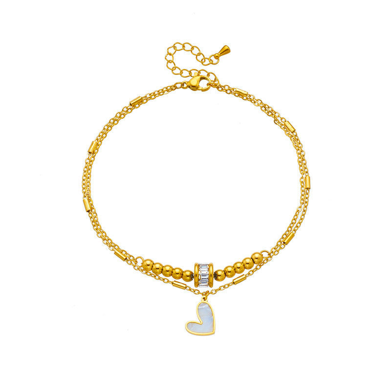 Gold double-layer heart anklet with heart charm and beaded chain accents