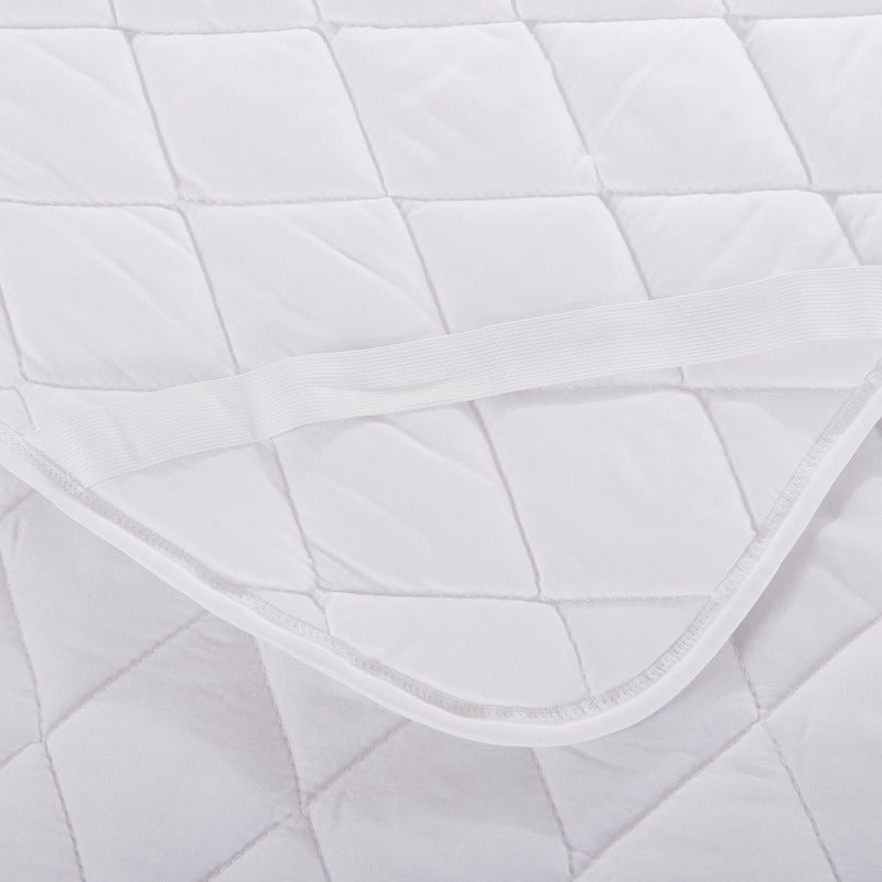 White quilted mattress topper fabric with curved stitched edge and close-up texture