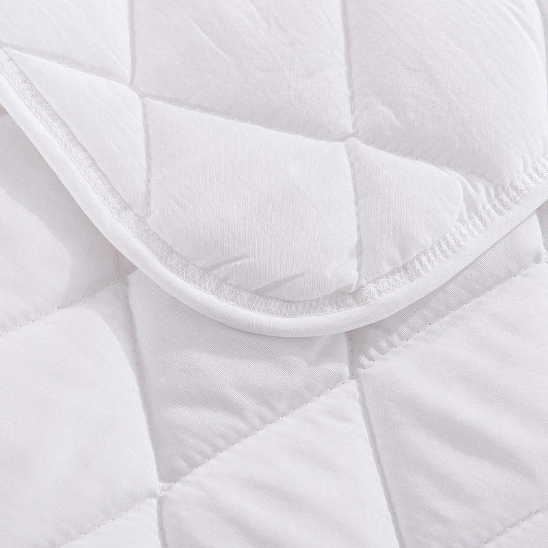 White quilted mattress topper corner with curved elastic trim and stitching detail