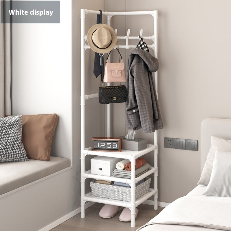 White corner coat rack with hanging hooks, hat on top, and multi-tier open storage shelves