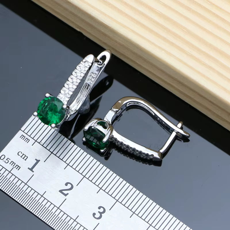 Sterling silver clasp with green oval gemstone and prong settings, matching link accents
