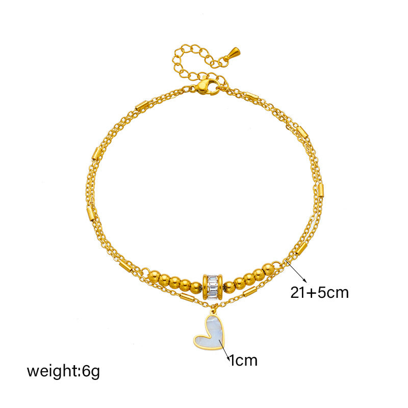 Gold double-layer heart anklet with heart charm and cylindrical clasp, adjustable length