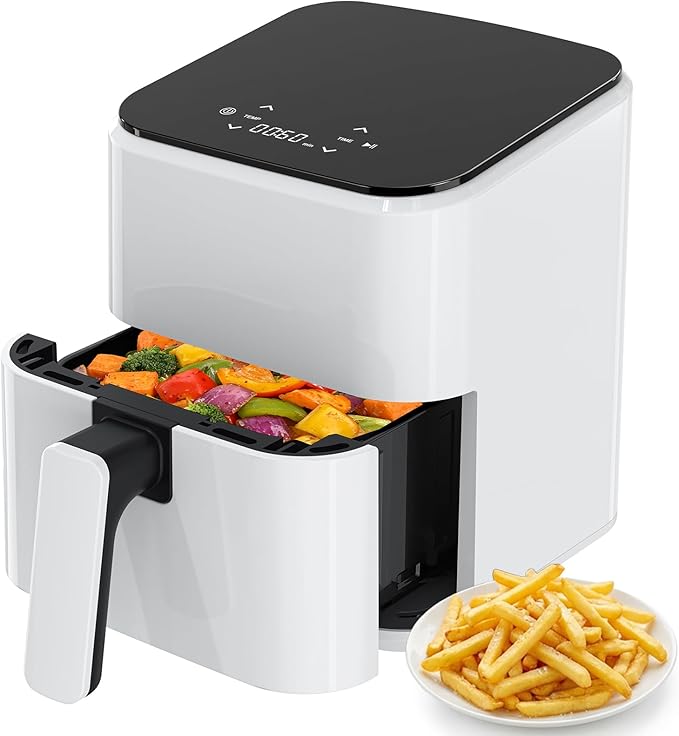 Compact air fryer, white body with black top; open basket holds mixed vegetables