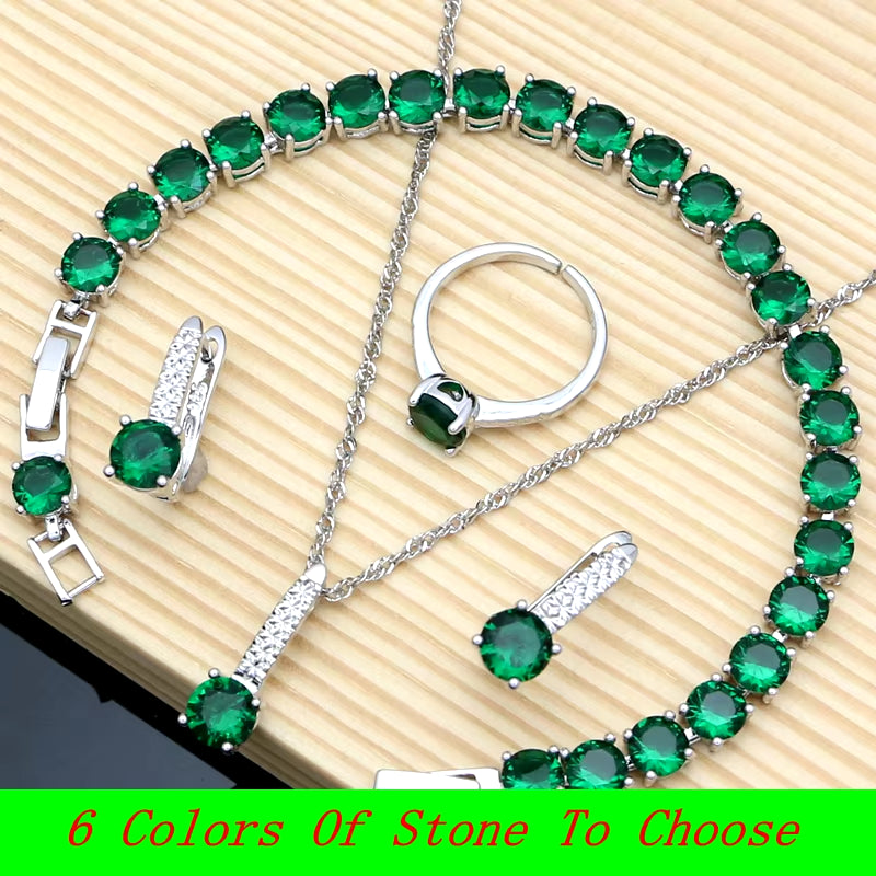 Sterling silver jewelry set with green gemstones: bracelet, necklace chain, ring, and earrings