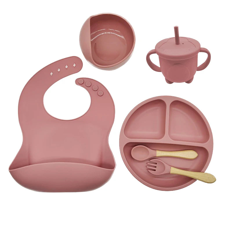 Baby silicone feeding set in dark pink: bib, divided suction plate, bowl, cup