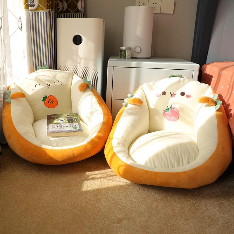 Round character floor cushion seat pad pair in cream with orange edge and carrot and strawberry faces.
