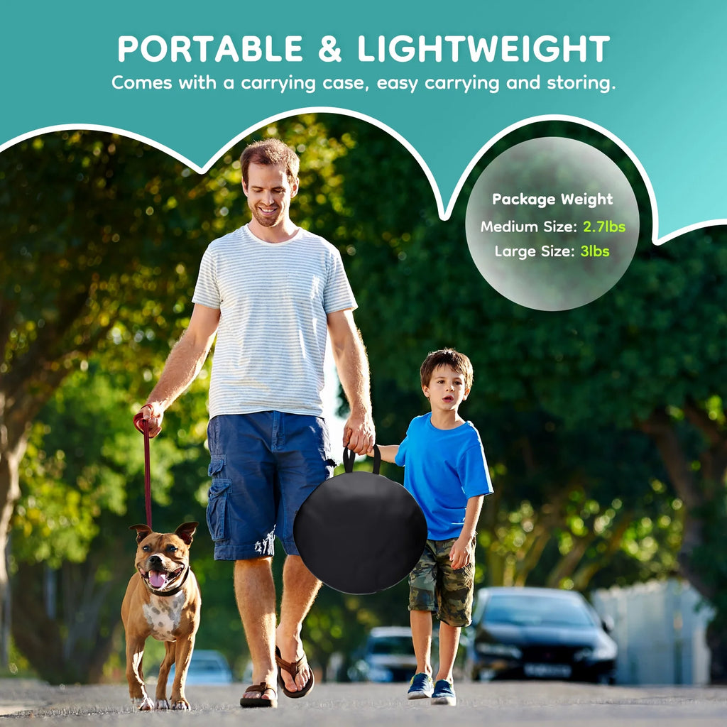 Black foldable pet playpen carry case with handle, with people and dogs outdoors.