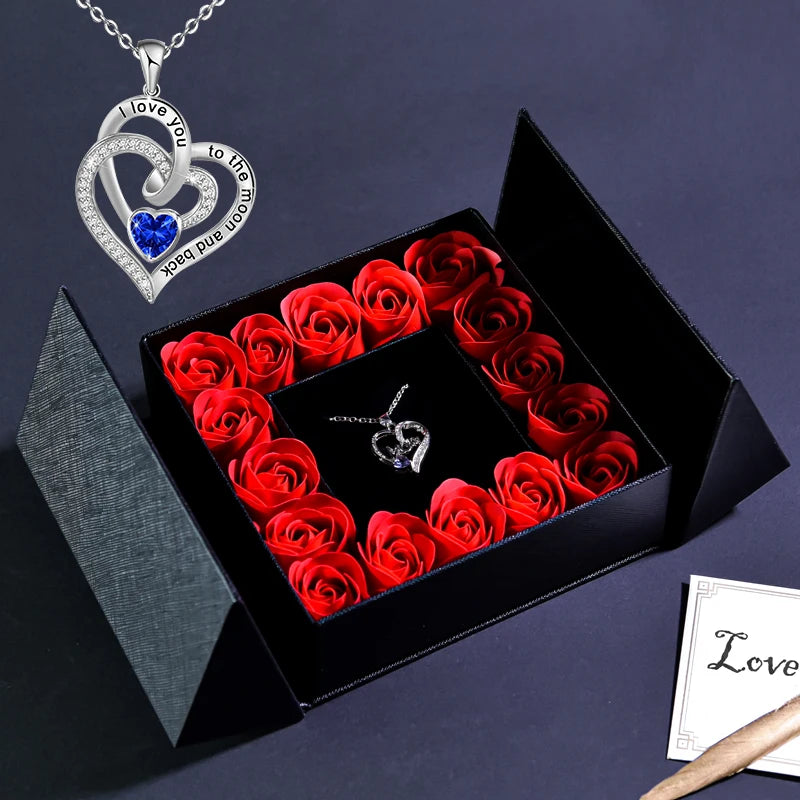 Jewelry box gift set with blue heart necklace pendant and red roses in black open box