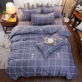 Cotton bedding set: navy duvet with white grid and mustache icons, plus matching pillowcases