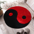 Round area rug with yin-yang style pattern, red and black split sections