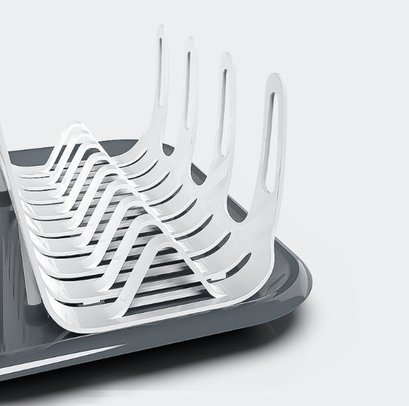 White dish drying rack with upright slots on dark base, folded for compact storage