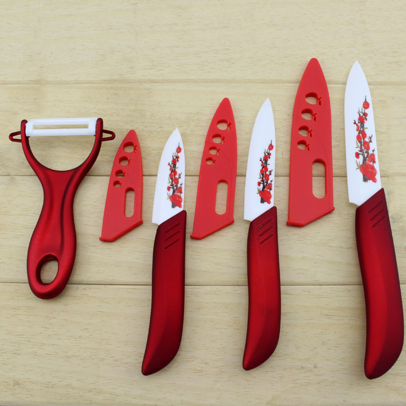 Red ceramic fruit knife set with peeler; four knives and blade covers