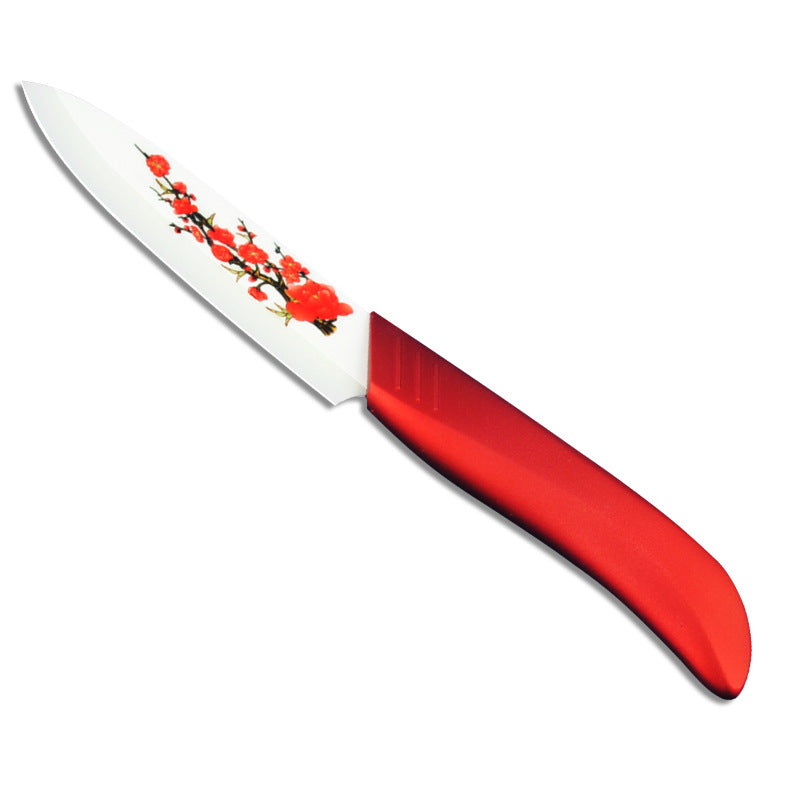 Red ceramic fruit knife with white blade and floral print