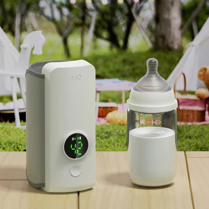 White baby bottle warmer next to an infant bottle on a table outdoors