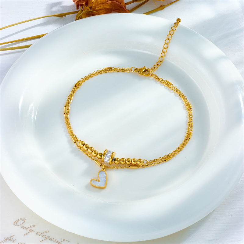 Gold double-layer heart anklet with heart pendant and linked chain centerpiece