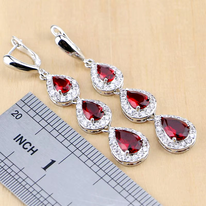 Sterling silver drop earrings with red teardrop gemstones and pavé halo