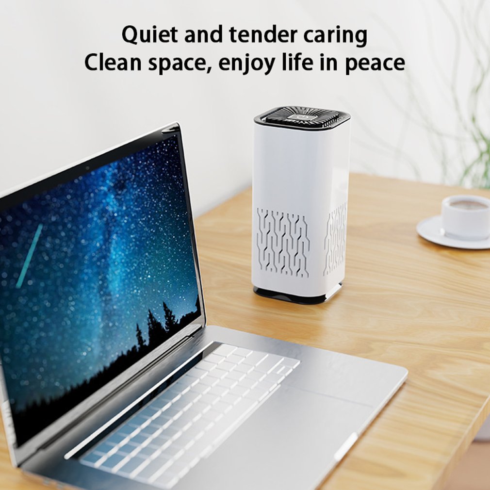 White portable air purifier on a wooden desk with vented side panels.