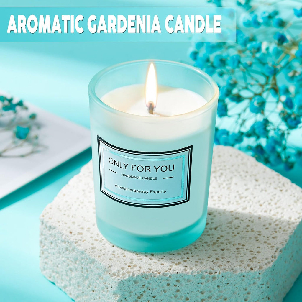 Aromatic gardenia candle in clear jar with blue wax and visible flame