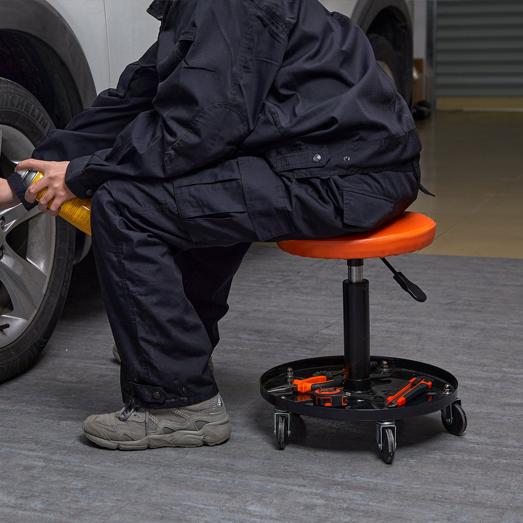 Orange rolling creeper seat stool with black tool tray and height control lever
