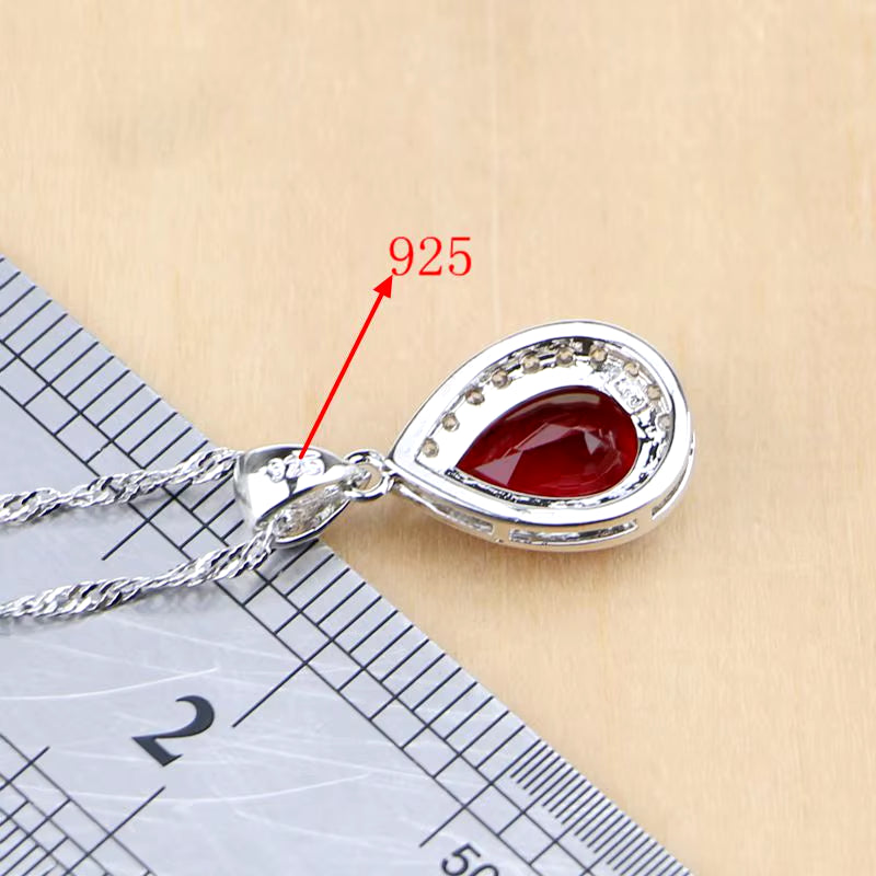 Sterling silver teardrop pendant necklace with red gemstone and pavé edge