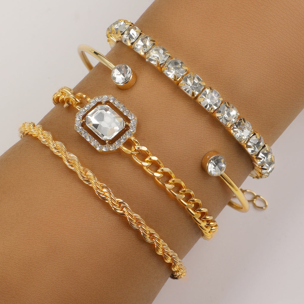 Gold-toned crystal bracelet set on wrist with square centerpiece, chain links, and cuff