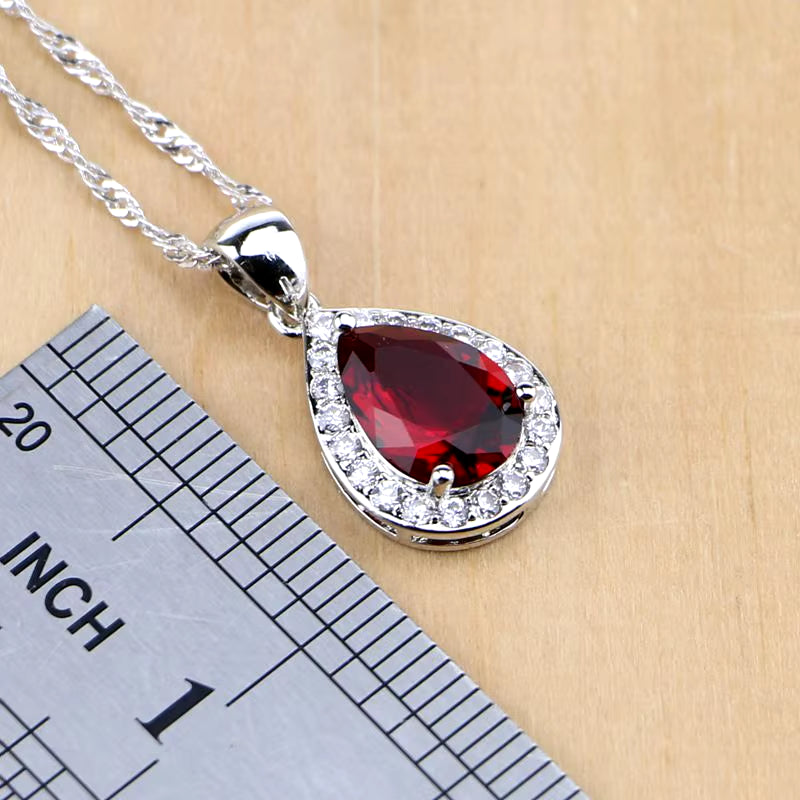 Sterling silver teardrop pendant necklace with red gemstone and pavé border