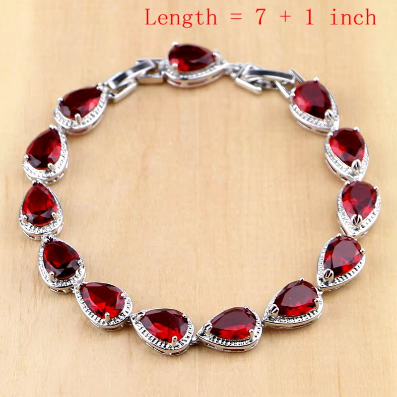Sterling silver bracelet with red teardrop gemstones in halo settings