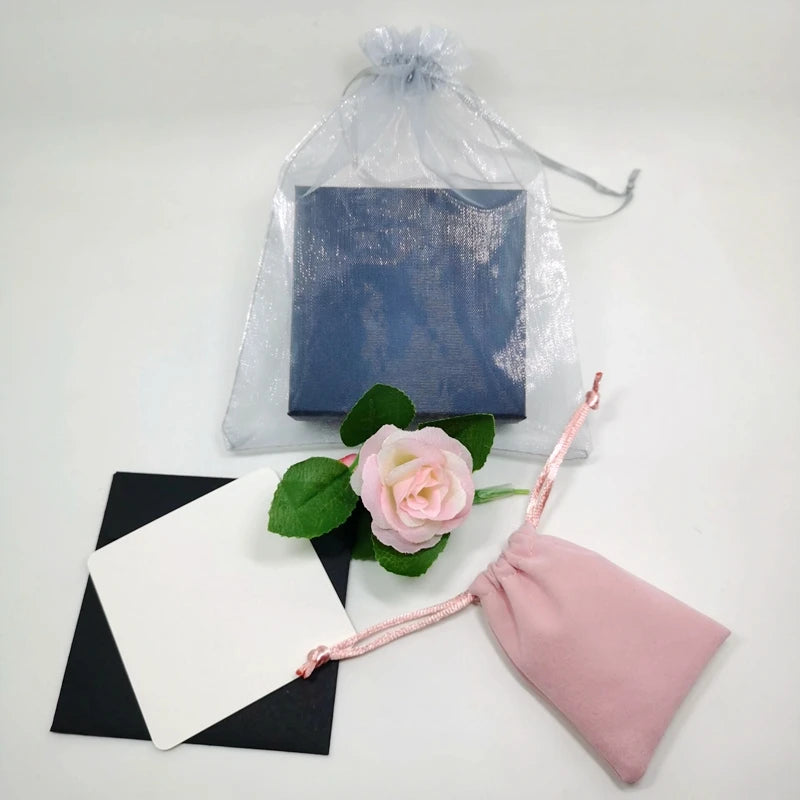 Wrapped gift pouch with ribbon and small jewelry accessory