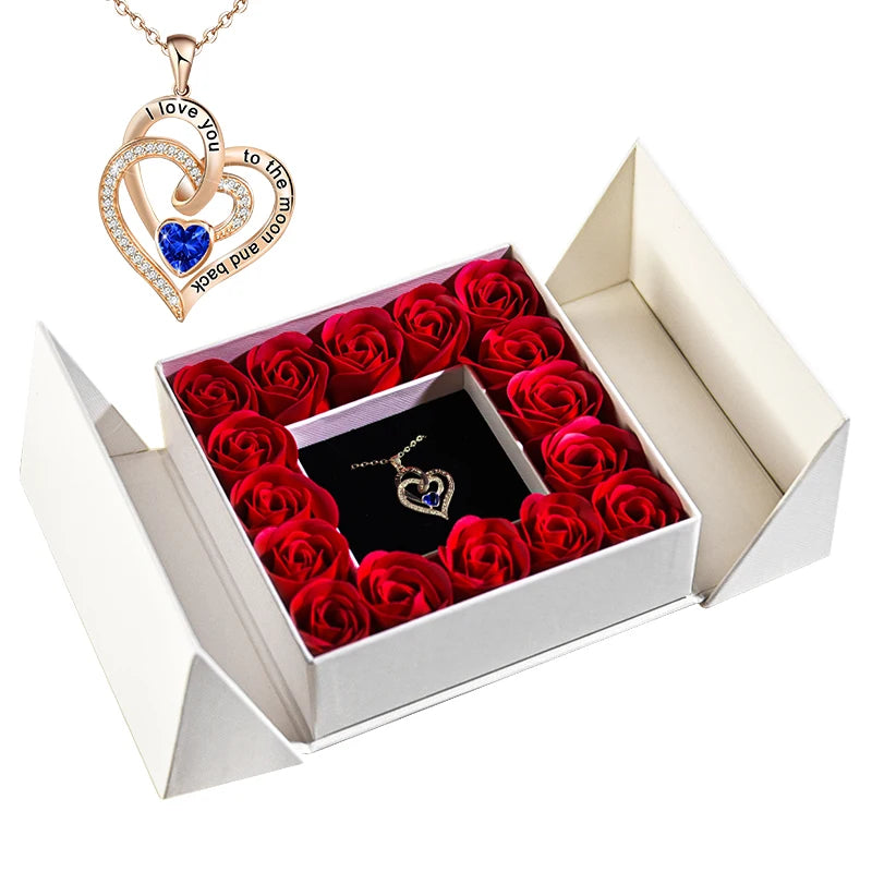 Jewelry box gift set with blue heart necklace pendant and red rose display in open box